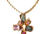 an image of a gold cross with multi colored stones on a chain
