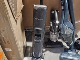 two vacuums that are on the floor next to a box