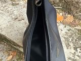 the inside of a black purse sitting on top of a stone step