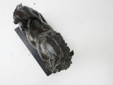 statue of a woman laying on a horse on a marble base
