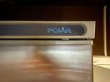a silver refrigerator with a sign on it that says polar
