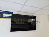 a flat screen tv hanging on the wall in a room