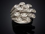 a close up of a diamond ring on a black surface