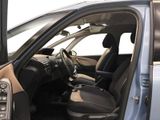 the interior of a car with the door open and the driver ' s seat down