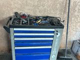 a blue tool cart with tools on top of it