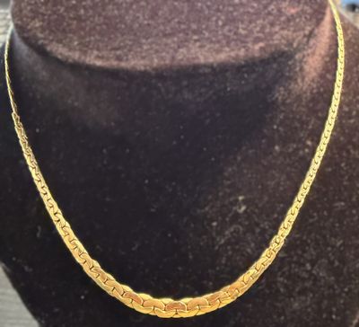 a gold necklace on a mannequin mannequin mannequin mannequin mannequin mannequin mannequin mannequin mannequin