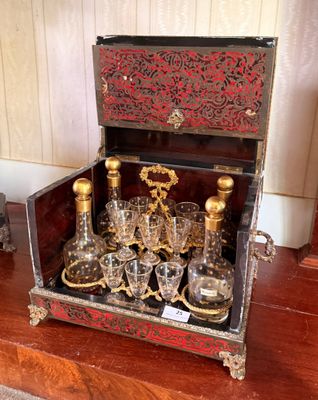 bottles and glasses in a wooden case on a wooden table