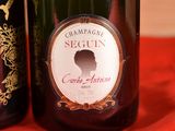 two bottles of wine on a red table cloth
