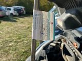 a car that has its hood open with a sticker attached to it