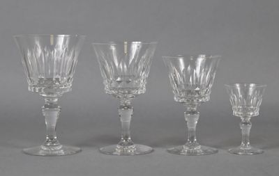 four clear wine glasses sitting next to each other on a table