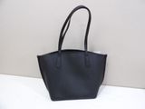 a black purse sitting on top of a white table