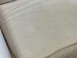 a white couch with pillows on it in a living room
