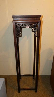 a tall wooden table with a mirror on top of it