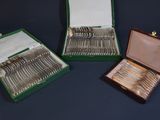 three boxes with silverware in them on a table