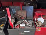 many different tools in a box on the floor