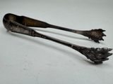 two spoons that are sitting next to each other