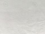a close up of a white towel with a red border on it