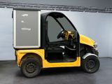 a small yellow truck that is parked in a room