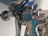 a close up of a spray gun on a table