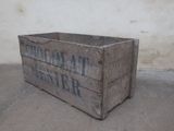 a wooden crate with a sign on it sitting on the ground