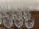 several empty wine glasses sitting on top of a wooden table