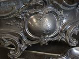 a silver clock that is sitting on a table