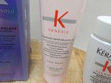 a bottle of kerastase and a tube of kerastase cream on a table