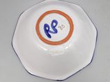 a white plate with a blue and orange design on it
