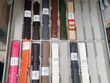a person holding a box full of different types of watches