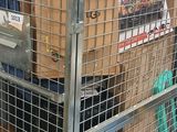 boxes are stacked on top of each other in a metal cage