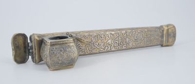 a metal object that is sitting on a white surface
