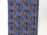 a close up of a tie on a white shirt