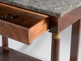 a wooden table with a marble top and a drawer on it