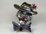a statue of a clown wearing a hat and a bow tie