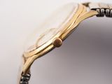 a close up of a watch on a white surface