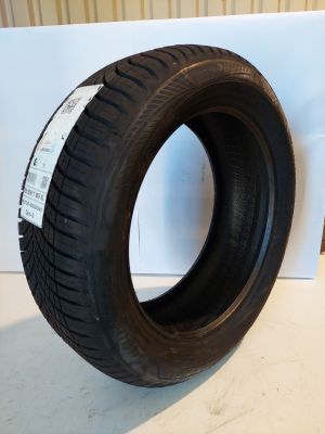 a close up of a tire on a white surface next to a wall