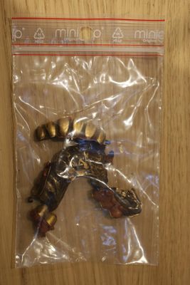 a bag with a toy figure in it sitting on a table