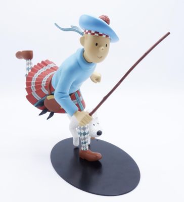 figurine représentant un homme tenant un club de golf, sur fond blanc