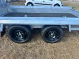 an image of a flatbed trailer parked in the grass