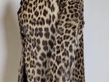 a close up of a leopard print jacket on a mannequin