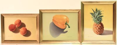three framed pictures of fruit and a pineapple on the wall