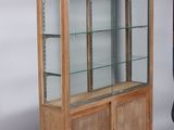 a wooden display case with glass shelves in it