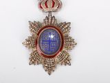 an image of a medal with a crown on it on a white surface