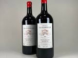 two bottles of wine sitting next to each other on a table