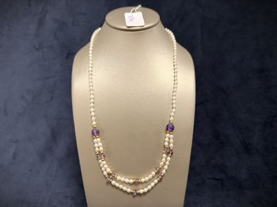 a close up of a necklace on a mannequin display