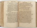 an open book on a white surface with a black border