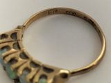 a gold ring with a blue stone in it