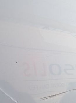 a plane that is flying in the sky with a sign on it