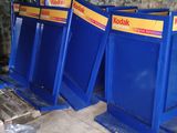 three blue bins that are sitting on the ground