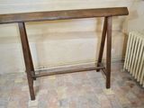 a wooden table that is sitting on a tiled floor